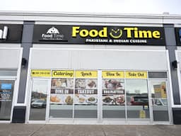 Food Time Whitby storefront — black & yellow signage